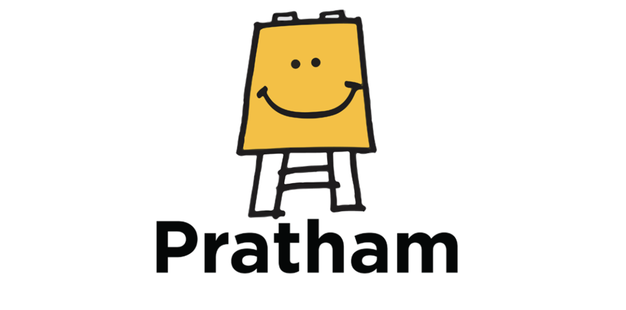 Pratham logo showing a school amber board with a smiley face on top of the black bold writing ‘Pratham’.