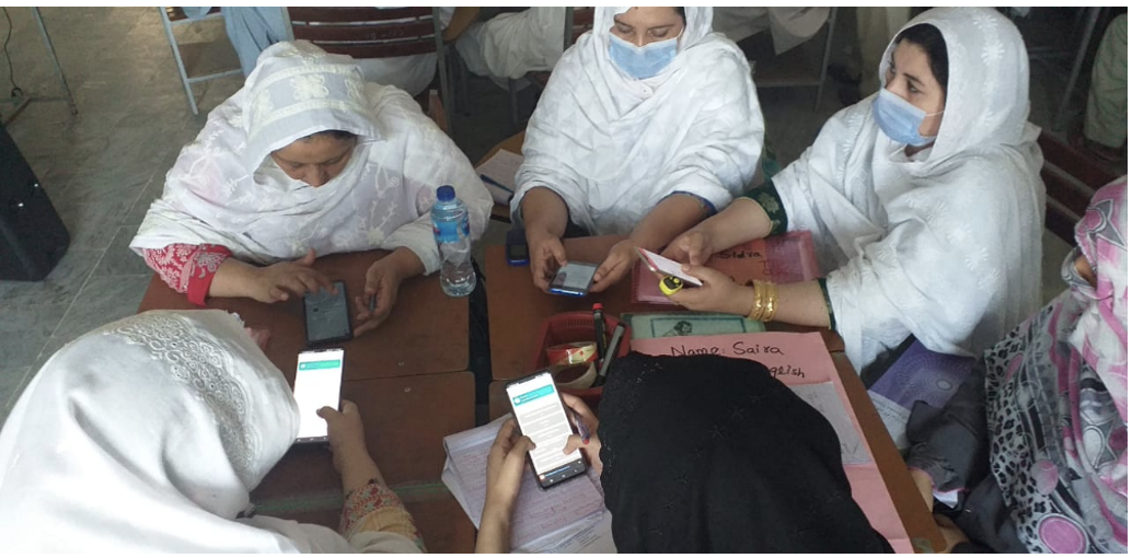 Photo showing some teachers using the tool on their smartphones.